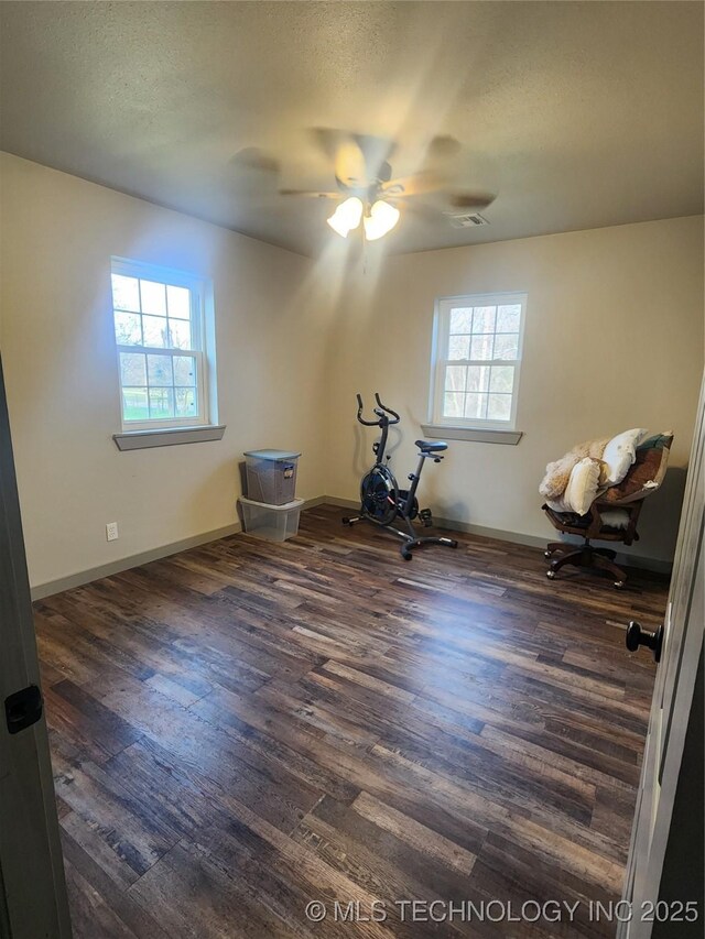 150 Birch Rd, Ardmore, OK 73401 - interior space featuring baseboards, plenty of natural light, and dark wood-style flooring