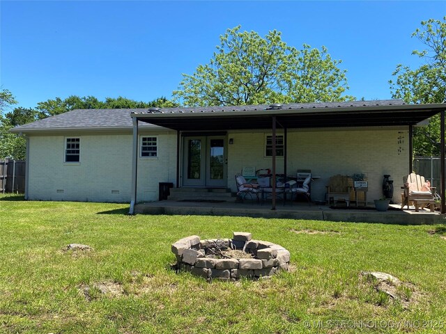 150 Birch Rd, Ardmore, OK 73401 - rear view of property featuring an outdoor fire pit, brick siding, crawl space, a lawn, and a patio