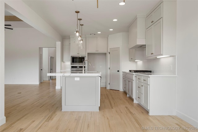 2038 E 129th St, Jenks, OK 74037 - kitchen featuring light countertops, stainless steel appliances, light wood finished floors, tasteful backsplash, and recessed lighting