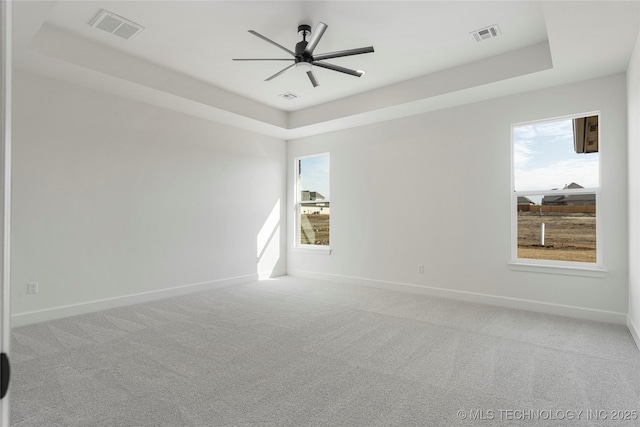 2038 E 129th St, Jenks, OK 74037 - spare room with a tray ceiling, a ceiling fan, carpet floors, and plenty of natural light