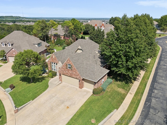 birds eye view of property with a residential view