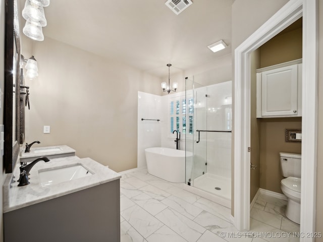 bathroom featuring visible vents, marble finish floor, a sink, a shower stall, and a soaking tub