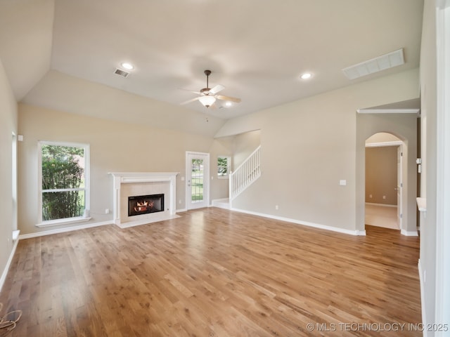 unfurnished living room featuring a ceiling fan, a high end fireplace, visible vents, and light wood-style flooring