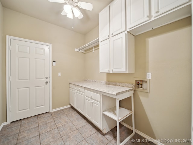 laundry area featuring baseboards, ceiling fan, hookup for a washing machine, light tile patterned flooring, and cabinet space