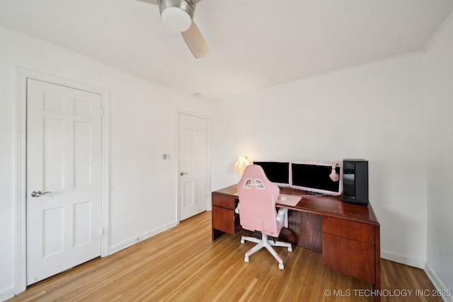 office featuring light wood finished floors, baseboards, and a ceiling fan