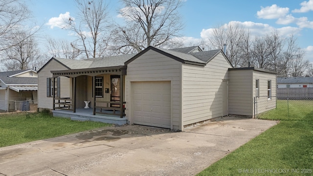 view of front facade with covered porch, concrete driveway, fence, a garage, and a front lawn