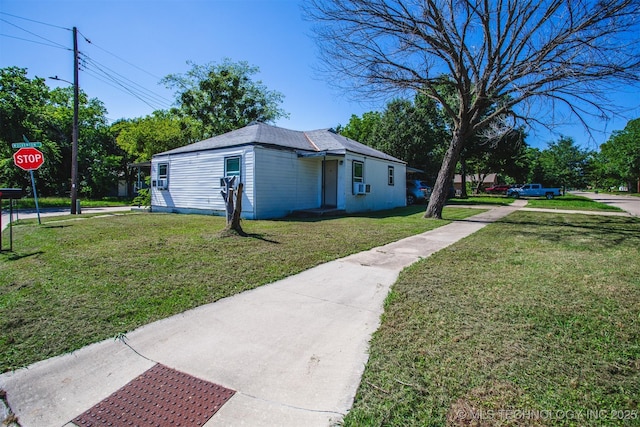 view of side of home with a lawn and cooling unit