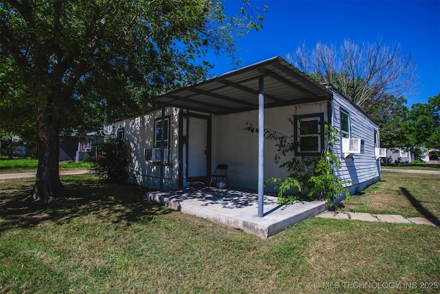 exterior space with a lawn, a patio area, and cooling unit