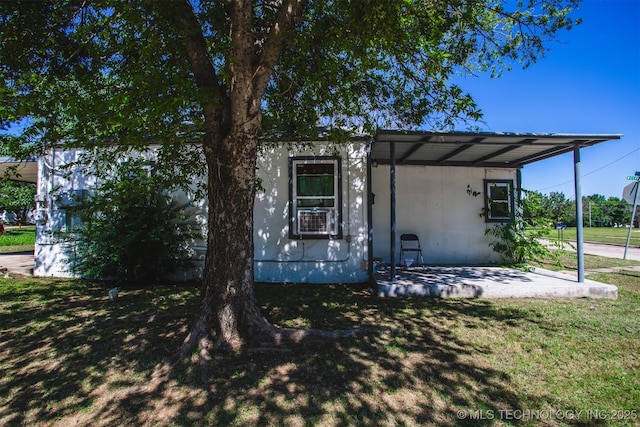 view of front of property with cooling unit and a front lawn