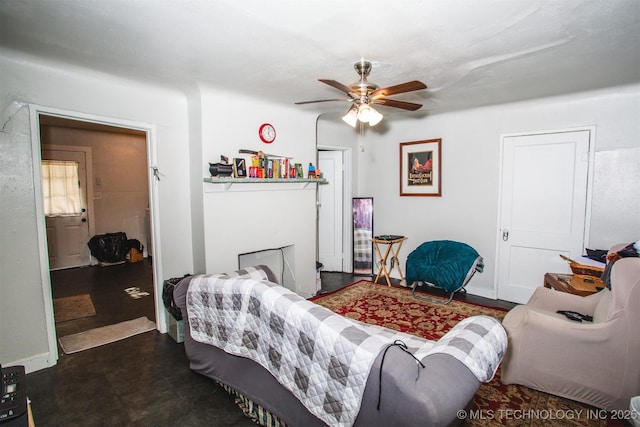 living area with a fireplace and ceiling fan