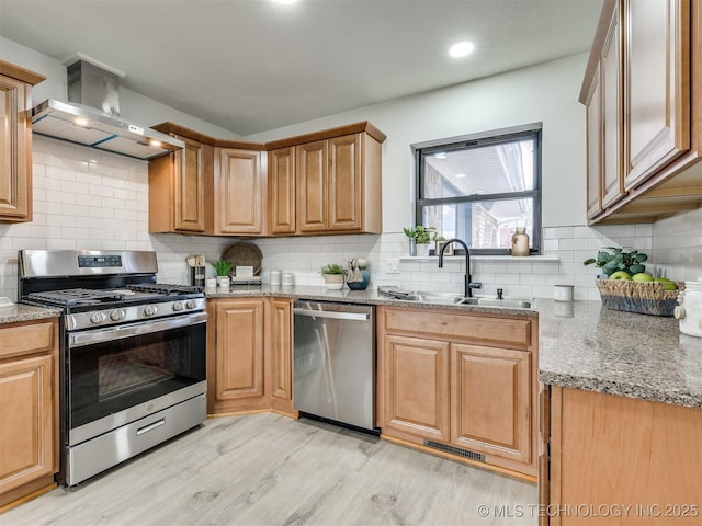 kitchen featuring visible vents, appliances with stainless steel finishes, light stone counters, and a sink