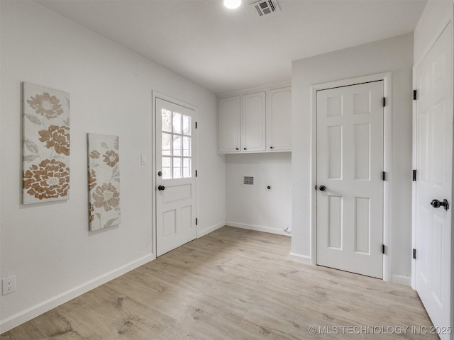 laundry area featuring cabinet space, visible vents, hookup for a washing machine, hookup for an electric dryer, and light wood-type flooring