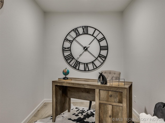 office with light wood-style flooring and baseboards