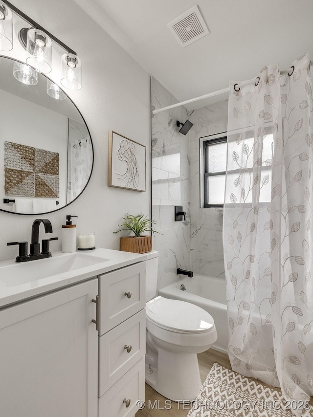 full bath with visible vents, toilet, wood finished floors, shower / bathtub combination with curtain, and vanity