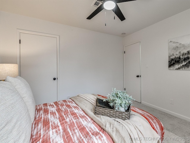 carpeted bedroom with baseboards, visible vents, and ceiling fan