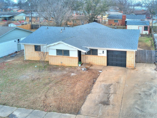 single story home featuring a garage, driveway, brick siding, and roof with shingles