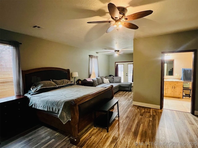 bedroom with visible vents, ceiling fan, baseboards, and wood finished floors
