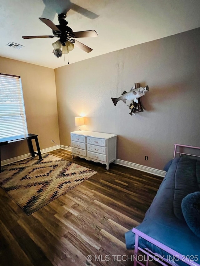 bedroom featuring ceiling fan, dark wood finished floors, visible vents, and baseboards