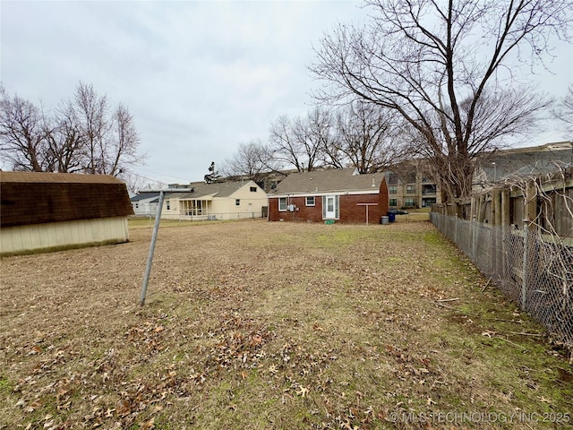 view of yard with fence and an outdoor structure