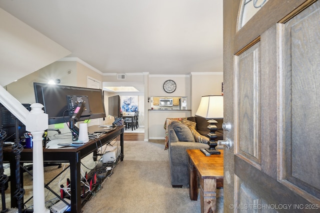 office space featuring baseboards, carpet floors, visible vents, and crown molding