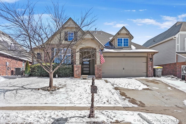 view of front facade with brick siding, concrete driveway, central AC unit, and a garage