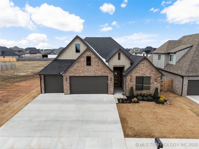 view of front of house featuring brick siding, fence, concrete driveway, roof with shingles, and board and batten siding