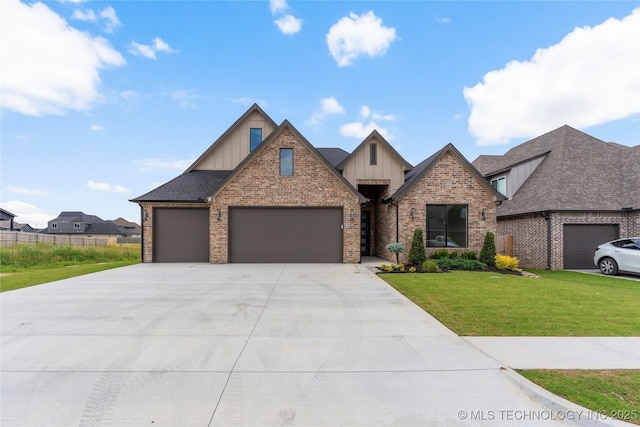 13630 S 21st Pl E, Bixby, OK 74008 - view of front facade with board and batten siding, a front lawn, a garage, concrete driveway, and brick siding