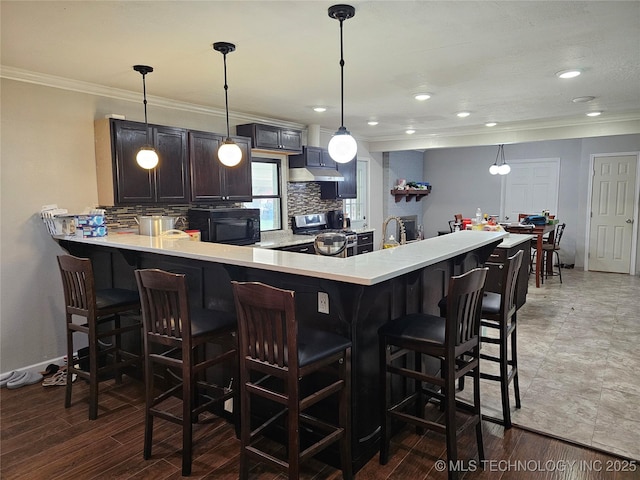 bar featuring decorative light fixtures, crown molding, and decorative backsplash