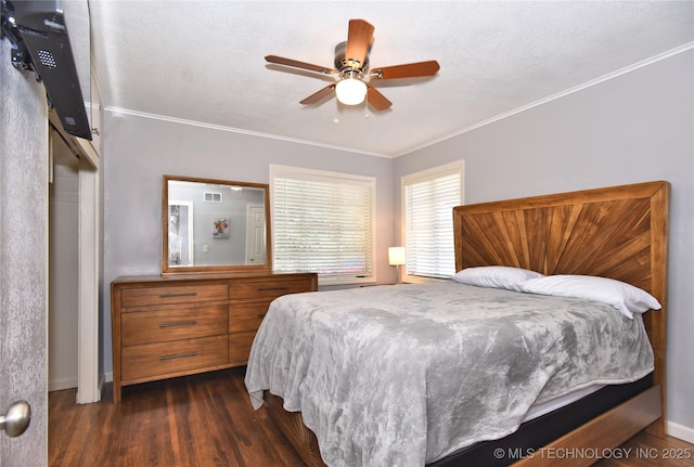 bedroom with a ceiling fan, baseboards, visible vents, dark wood-style floors, and crown molding