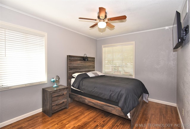 bedroom with crown molding, dark wood finished floors, baseboards, and ceiling fan