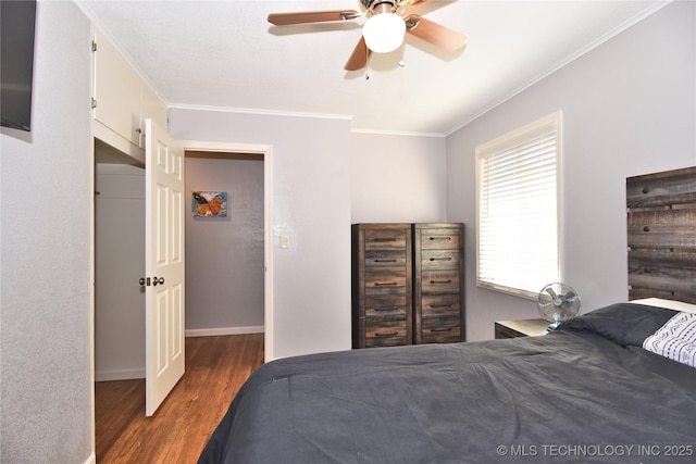 bedroom featuring ceiling fan, ornamental molding, dark wood-style flooring, and baseboards