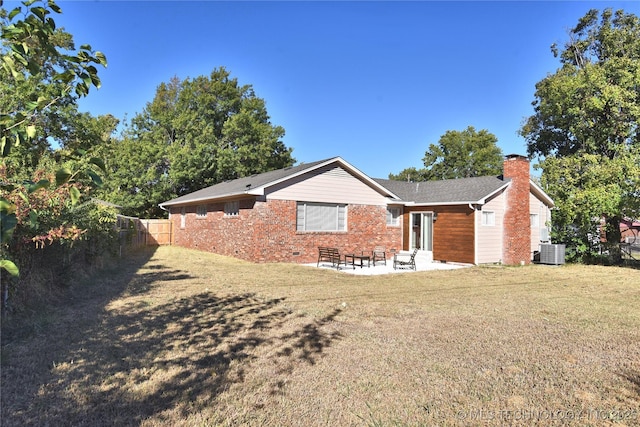 view of front of property with a patio, cooling unit, fence, crawl space, and a chimney