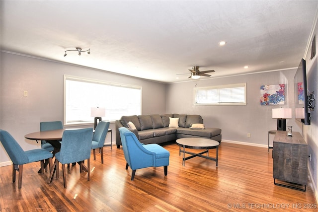 living room featuring recessed lighting, wood finished floors, a ceiling fan, baseboards, and crown molding