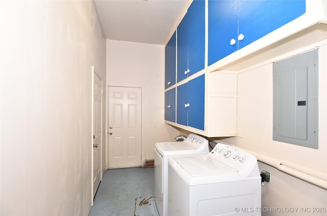 washroom featuring cabinet space, washing machine and dryer, and electric panel