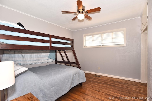 bedroom with baseboards, visible vents, dark wood finished floors, ceiling fan, and ornamental molding