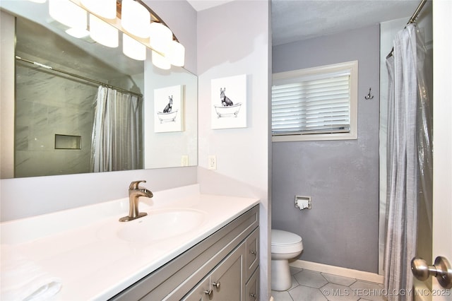 bathroom featuring curtained shower, toilet, vanity, tile patterned flooring, and baseboards