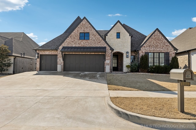 french provincial home with a garage, driveway, brick siding, and roof with shingles