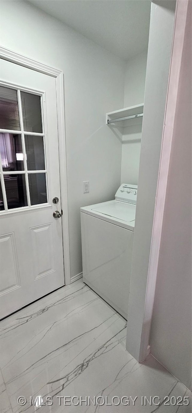 laundry room featuring washer / clothes dryer, marble finish floor, and laundry area