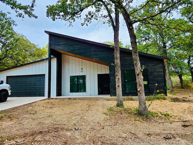 exterior space with concrete driveway and an attached garage