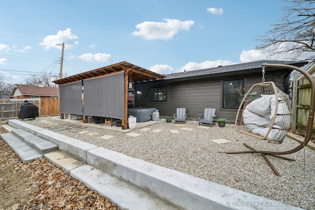 view of property exterior with fence and a hot tub