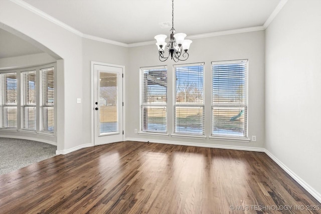 unfurnished dining area featuring arched walkways, a healthy amount of sunlight, and crown molding