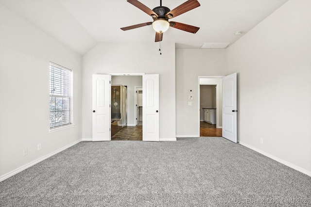 unfurnished bedroom featuring vaulted ceiling, ceiling fan, dark carpet, and baseboards