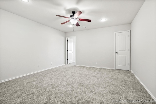 carpeted empty room featuring visible vents, recessed lighting, a ceiling fan, and baseboards