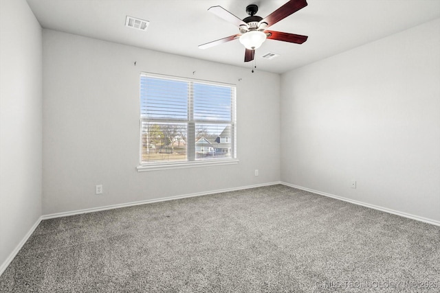 unfurnished room featuring baseboards, carpet flooring, visible vents, and a ceiling fan