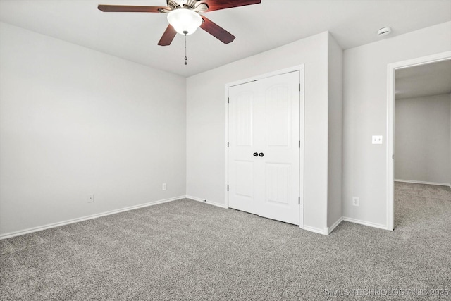 unfurnished bedroom with carpet floors, baseboards, and a ceiling fan