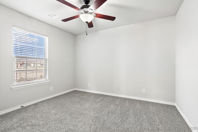 empty room featuring a ceiling fan, carpet flooring, visible vents, and baseboards