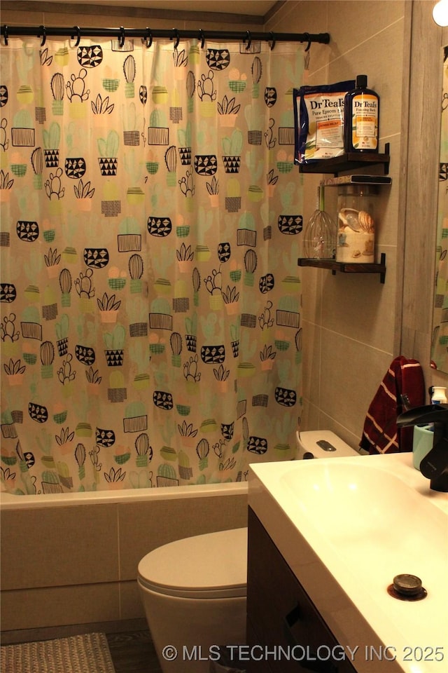 bathroom featuring toilet, shower / bath combo, tile walls, and vanity