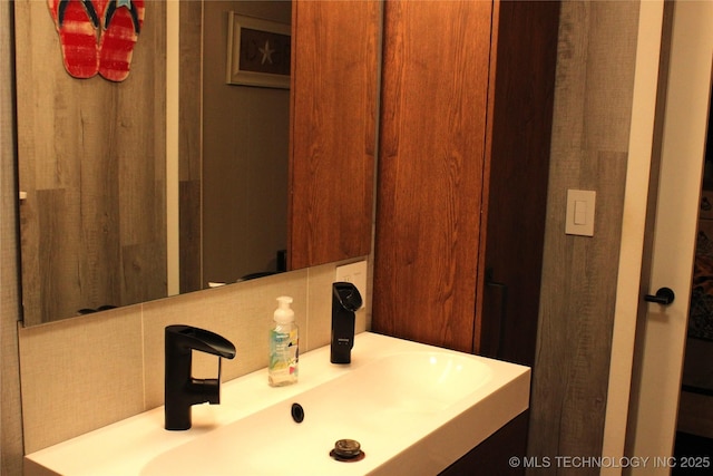 bathroom with backsplash and a sink