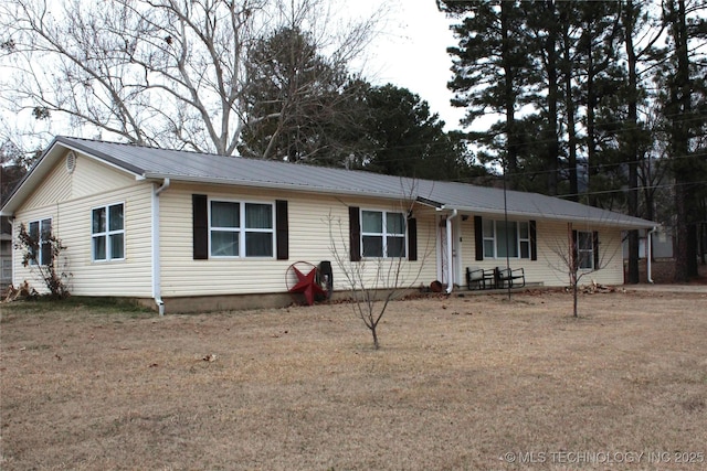 ranch-style home with metal roof and a front yard