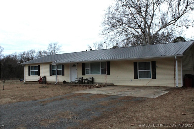 ranch-style home with metal roof